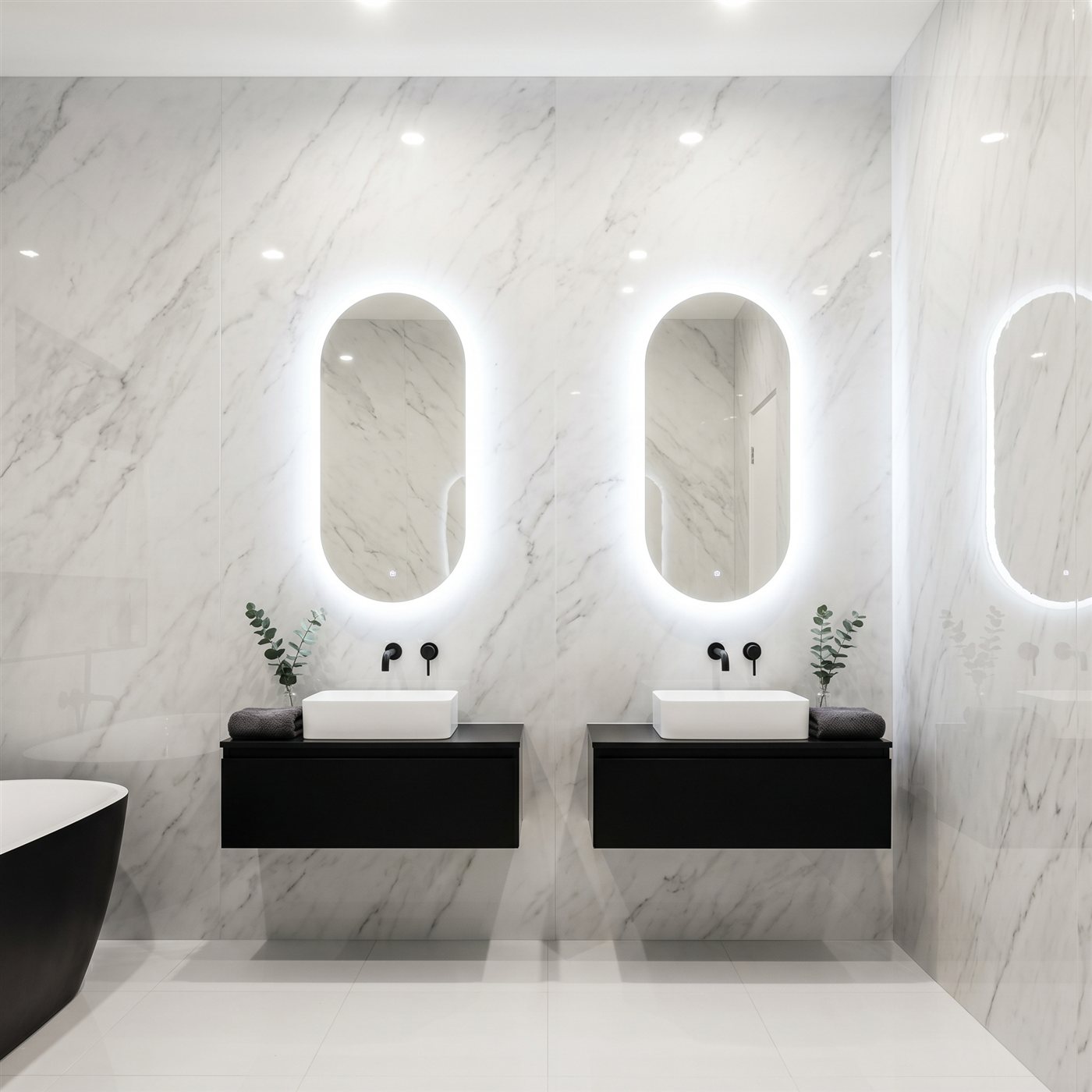 Bright bathroom with double vanity, marble walls and backlit mirrors